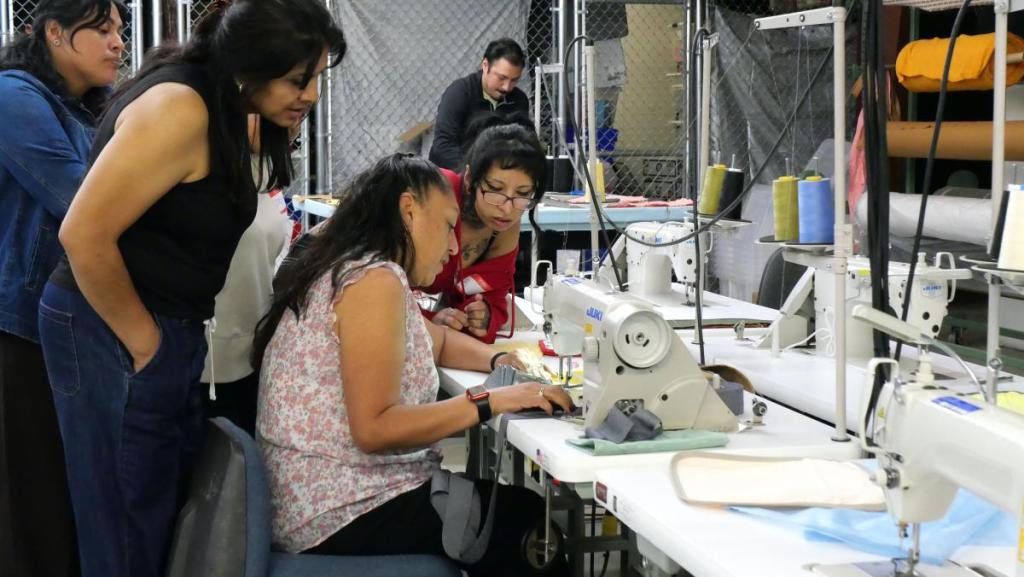 A Saturday afternoon at the Poder Emma Industrial Sewing Workshop. Students must complete 80 hours of coursework and finish 12 sewing projects to earn certification. Photo: Patricia Serrano / ELNC